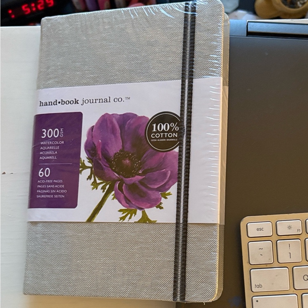 Journal. Gray cover. Fabric. Still in plastic. Watercolor paper. Elastic band